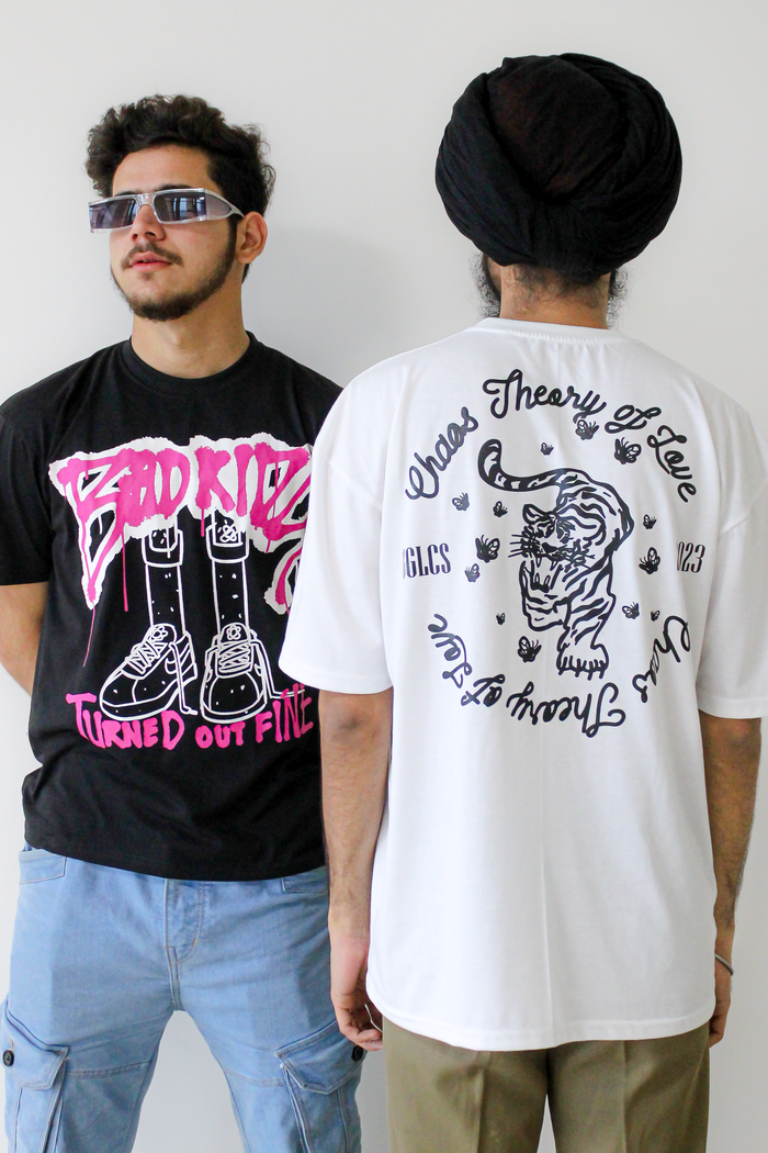 Two young men in graphic T-shirts and sunglasses showcase modern streetwear style.